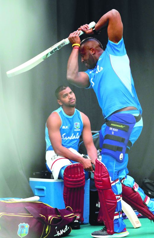 Andre Russell (right) of the West Indies is watched by teammate Nicholas Pooran at a training session at the Rose Bowl in Southampton on Thursday. (Photo: AFP)
