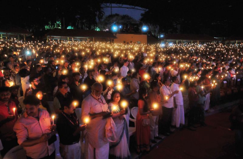People at the opening ceremony of the 22nd IFFK on Friday hold candles in solidarity with the victims of Ockhi tragedy.