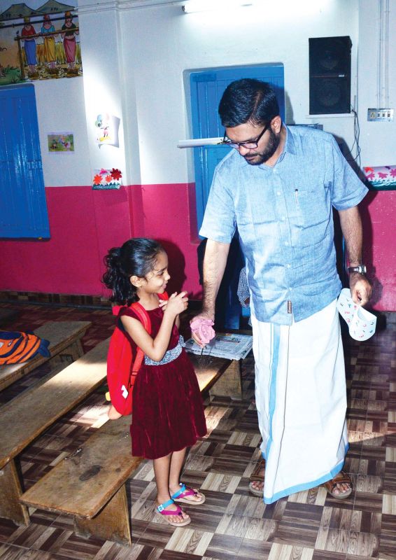 M.B. Rajesh, MP, takes daughter Priyadatha to her classroom at Palakkad East Yakkara Government Lower Primary School after enrolment.