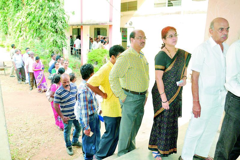 eople stand in a queue to cast their vote for Graduates' MLC polls at VS Krishna College in Vizag on Thursday.