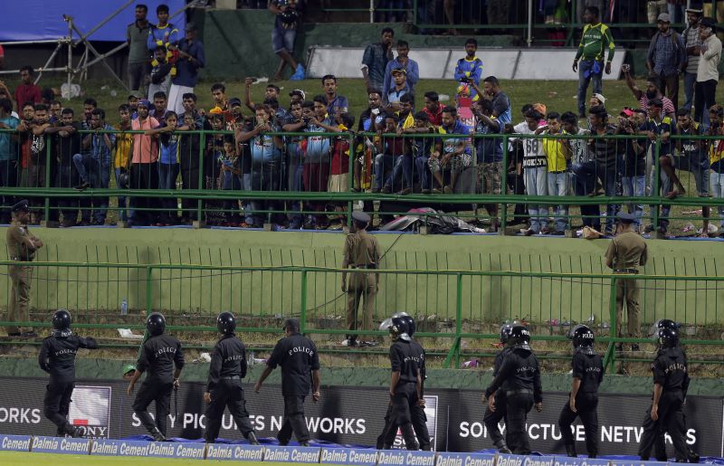 Security forces were called to clear the spectators from some of the sections in the gallery before the match resumed. (Photo: AP)