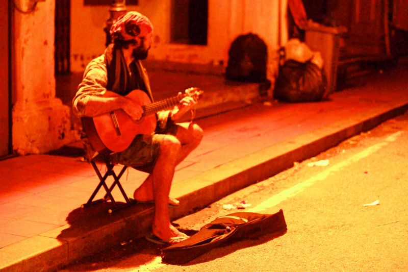 A street musician; (left) The trishaws flocking the streets