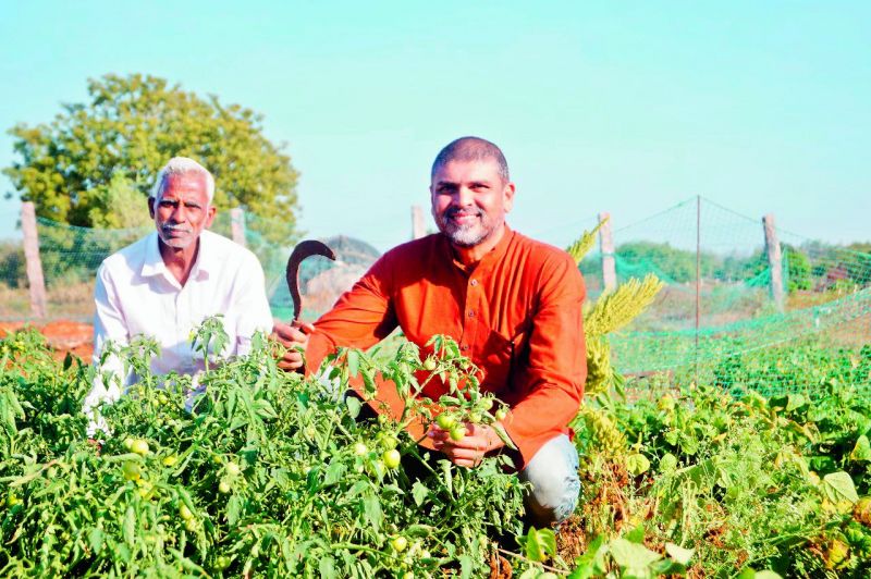 Mujtaba Askari (on the right) with an employee in his farm