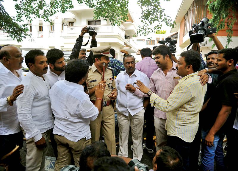 Supporters of Energy Minister D.K Shivakumar in front of his house in Bengaluru during IT raids on Friday