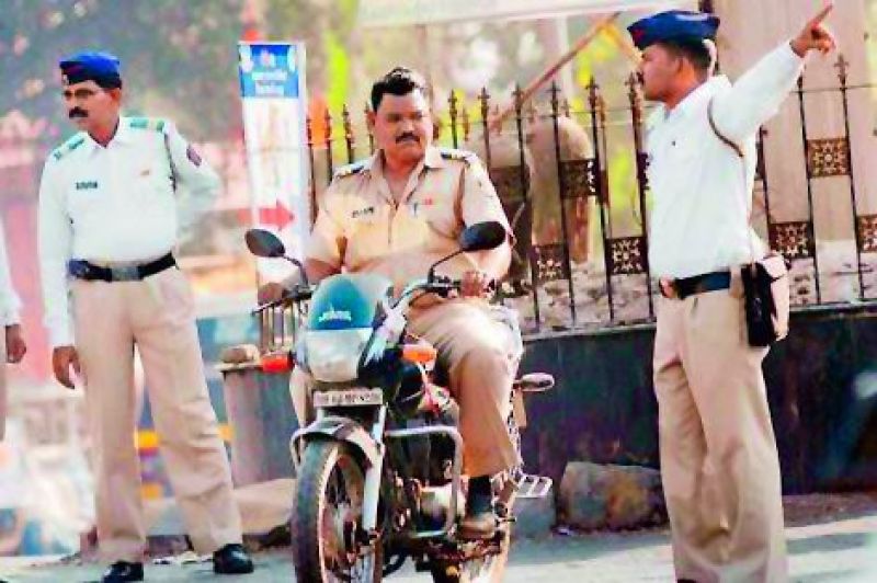 A cop riding his bike without a helmet