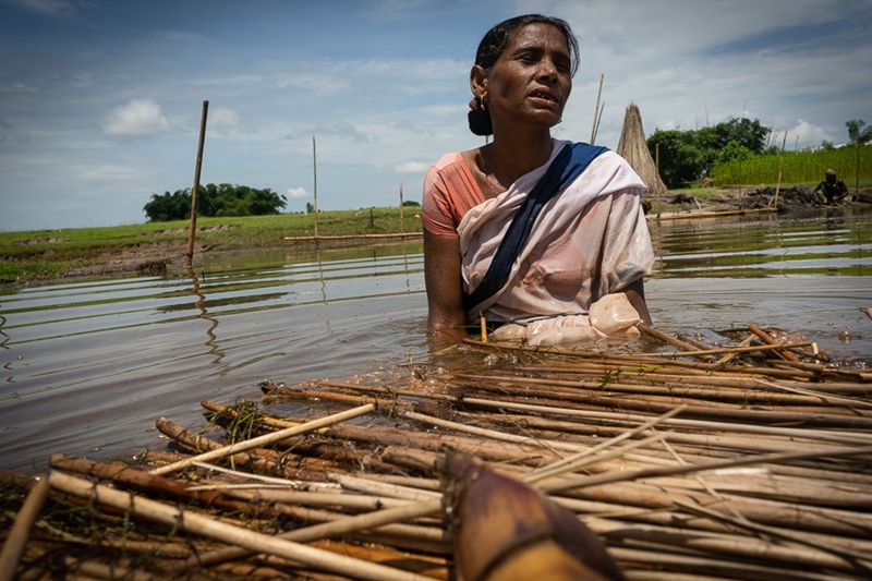 Without the manual effort of ASHA Abaron Bibi, the raft cannot move. She wades through the waters, tugging the raft across the wetland all by herself in an extremely hot and humid condition. (Photo: MoHFW)