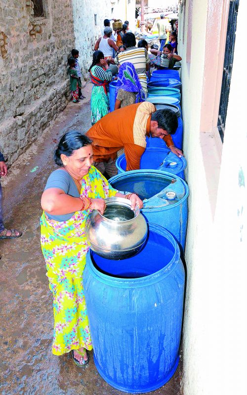 Residents from Bhoiguda Kaman and Nampally are forced to collect water from available source  after a pipeline leakage in Mallepally stopped water supply for the past four days.  (Photo: P. Surendra)