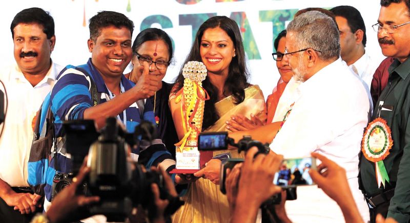 Photojournalist Arunchandra Bose receives the Best Coverage' award for DC in Adimali on Sunday. 