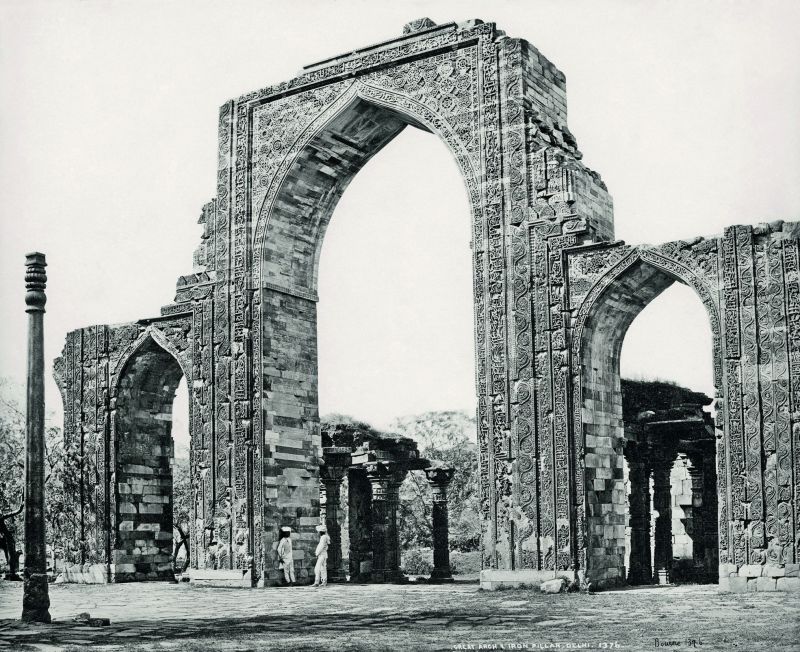 Delhi, The Great Arch and the Iron Pillar at the Qutub Minar.