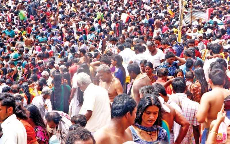 Devotees take a holy dip in Cauvery in Bhavani Kooduthurai during Maha Pushkaram festival in Erode district on Sunday (Photo: DC)