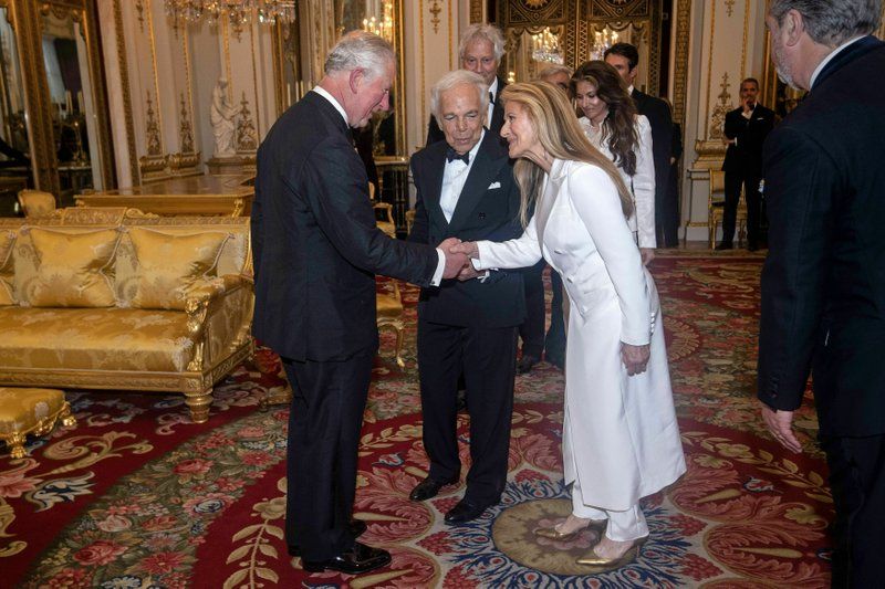 The Prince of Wales, designer Ralph Lauren, center, and his wife Ricky Lauren after he was presented with his honorary KBE (Knight Commander of the Order of the British Empire) for Services to Fashion in a private ceremony at Buckingham Palace. (Photo: AP)