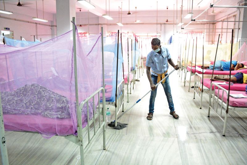 Staff at the special ward for dengue at RGGGH wears a safety mask while cleaning the room. (Photo: DC)