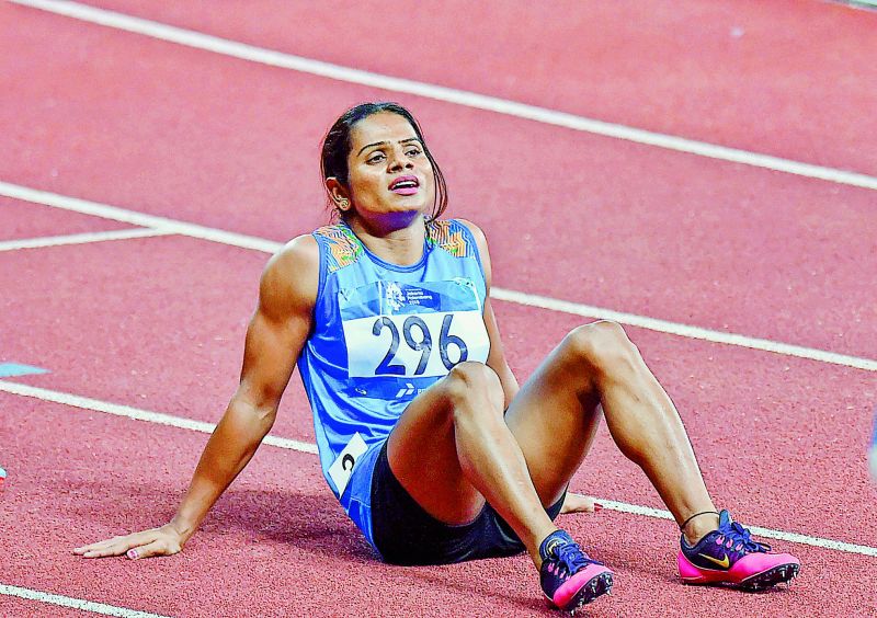 Dutee Chand rests after crossing the finish line to win silver medal in the women's 200m in Jakarta on Wednesday.  (Photo:PTI)