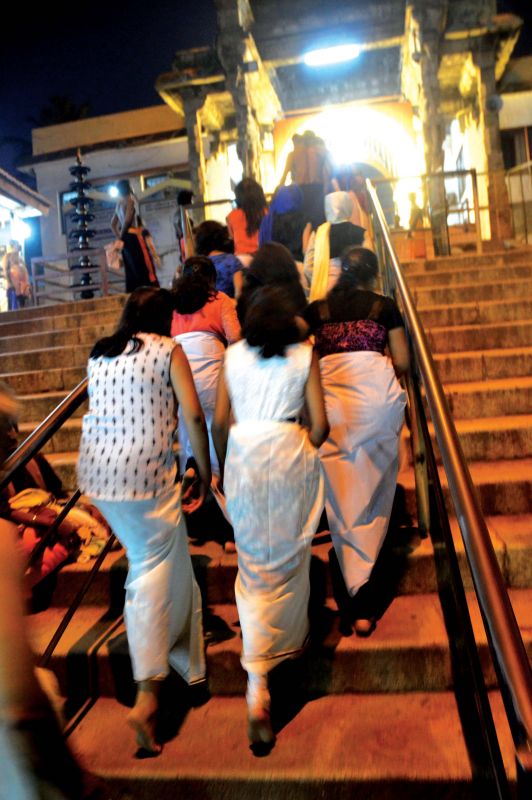 Female devotees enter the Padmanabha Swamy temple in dhoti wrap on Tuesday. (Photo: DC)