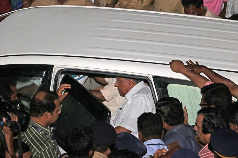 Chief Minister Pinarayi Vijayan gets into minister Kadakampally Surendran's car after an angry crowd stopped him from boarding his official vehicle. (Photo: DC)