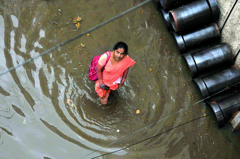 A woman walks through water in Malakpet. (Photo: DC)
