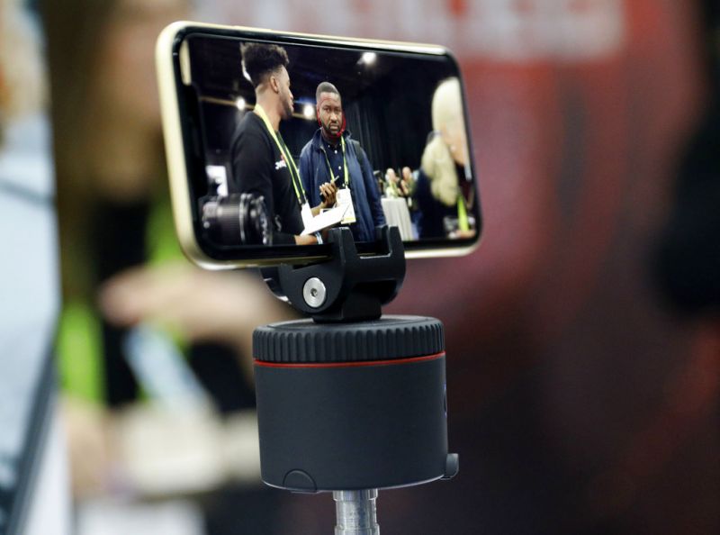 The Pivo is on display at the Pivo booth during CES Unveiled at CES International, Sunday, Jan. 6, 2019, in Las Vegas. The device and app allows your phone to move to follow faces or objects for photos and video, among other modes. (AP Photo/John Locher)