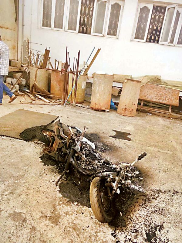 The remains of  a burnt two-wheeler after violence gripped Sirsi town in Uttara Kannada district on Tuesday with BJP  workers protesting against the killing' of their activist, Paresh Mesta.