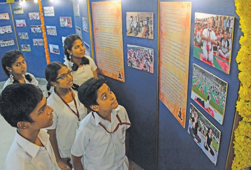 Students of Maharishi Vidya Mandir Senior Secondary School in Chennai take a look at a yoga themed photo  exhibition on their campus. (Photo: DC)