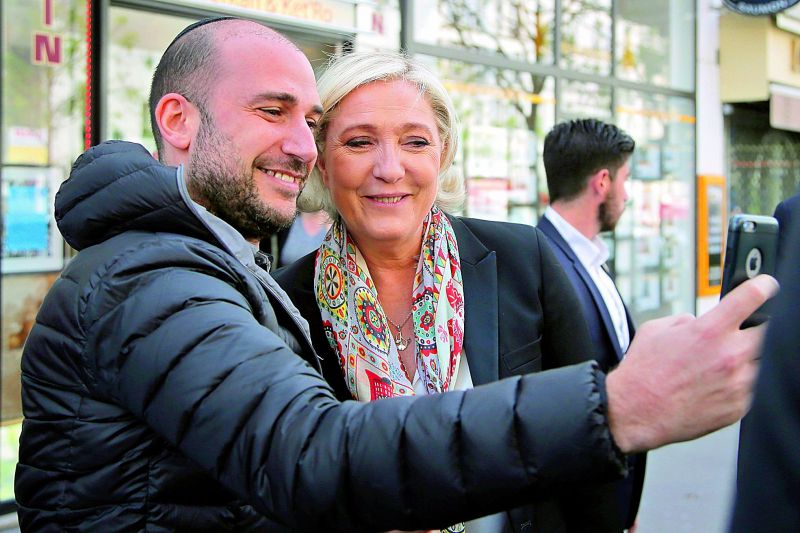 French far-right leader Marine Le Pen poses for a selfie after a haircut in Paris on Monday. (Photo: AP)