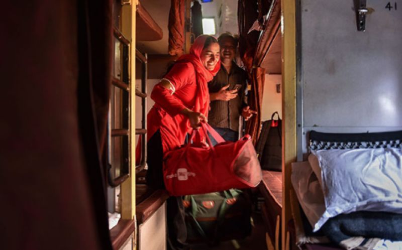 Manju Devi hauls luggage of a passenger inside a train compartment, at the railway station in Jaipur, on Sunday, May 20, 2018. Manju stands tall in her fraternity, being the first woman coolie (porter) of North Western Railway (Photo: PTI)