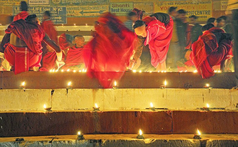 Lighting oil lamps on the ghats of Varanasi