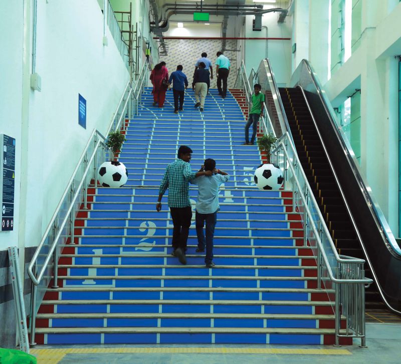 Staircase of JLN Stadium station set up on the synthetic track theme.