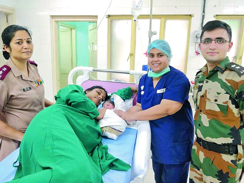 Sajitha with her newborn at hospital.