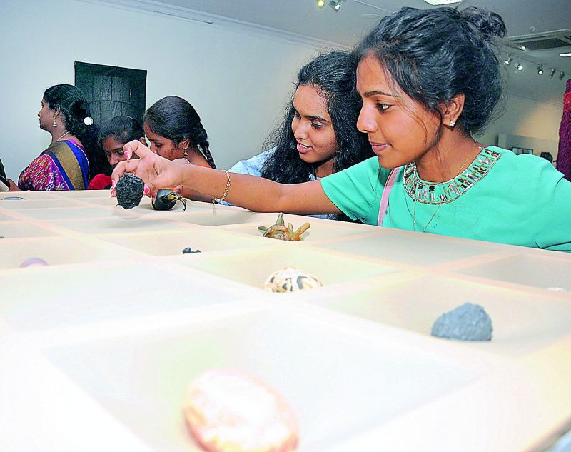 Students checking out small artifacts at display