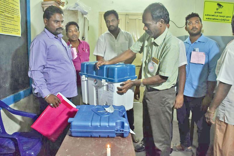 Election officers secure electronic voting machines after polling ended at a booth in Nethaji Nagar. (Photo: DC)