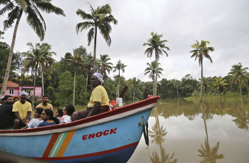A group of people are taken in a boat after they were rescued from a flooded area in Chengannur in Kerala. (Photo: AP)