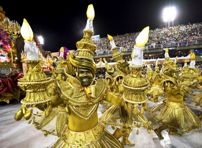 Members of the Viradouro school samba through the 700 meter Sambradrome in Rio's carnival: each school fields hundreds, if not thousands, of dancers, as well as floats and drummers. (Photo: AFP)