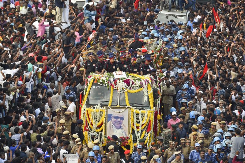 People gather to pay their last respects to DMK chief M Karunanidhi as his cortege passes through the streets of Chennai. (Photo: PTI)