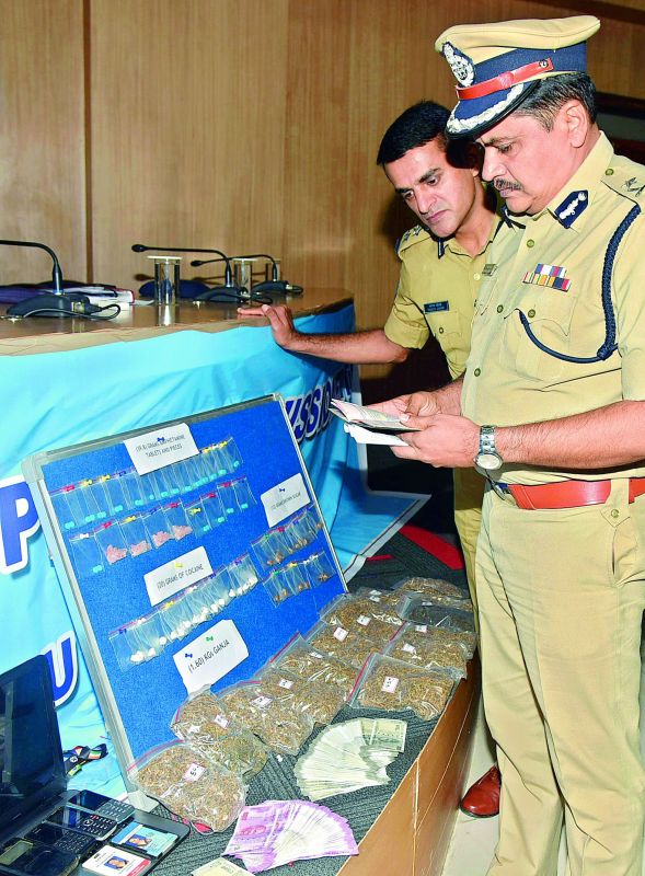 Commissioner Mahesh Bhagwat inspecting the drugs seized  from the Nigerians. (Photo: DC)