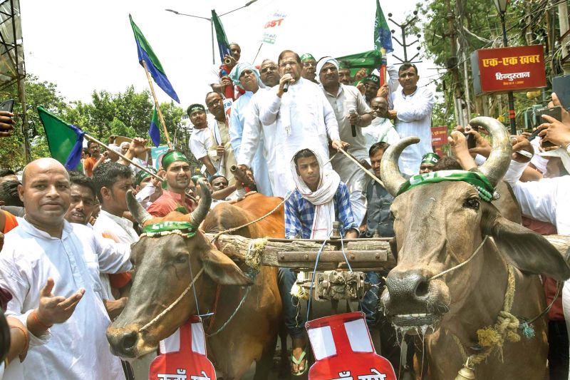 In Navi Mumbai; Loktantrik Janata Dal leader Sharad Yadav rides a bullock-cart  during a protest against steep hike in fuel prices, in Patna. 