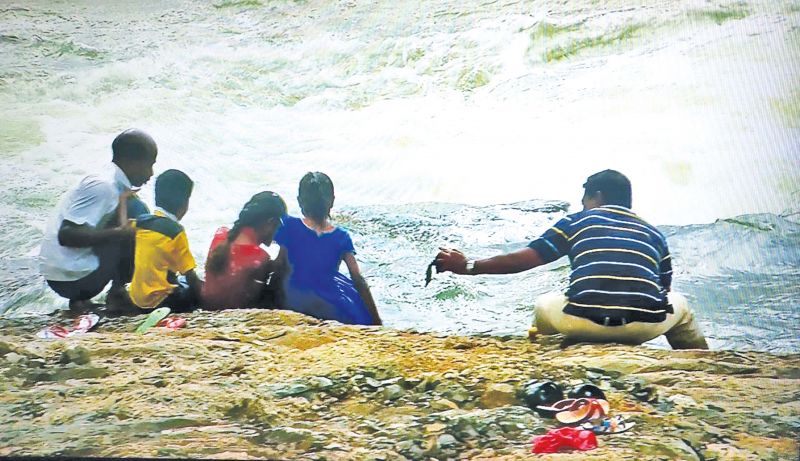 Despite the flood warning people revel near the river bank in Mettur.(Photo: DC)