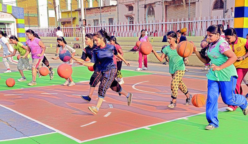 Girls practise dribbling during a basketball summer camp coaching session organised at the Victory Playground in Hyderabad. (Photo: DC)