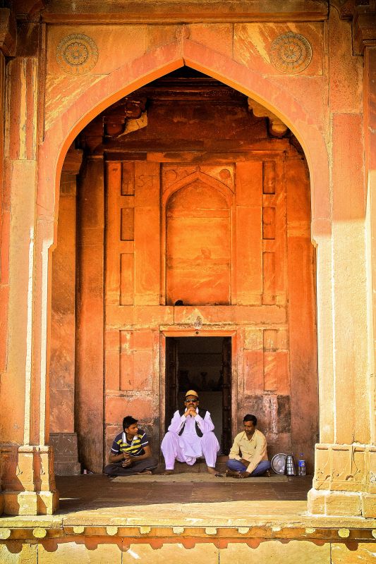 Men indulge in a chit-chat at one of the doors of Agra Fort.