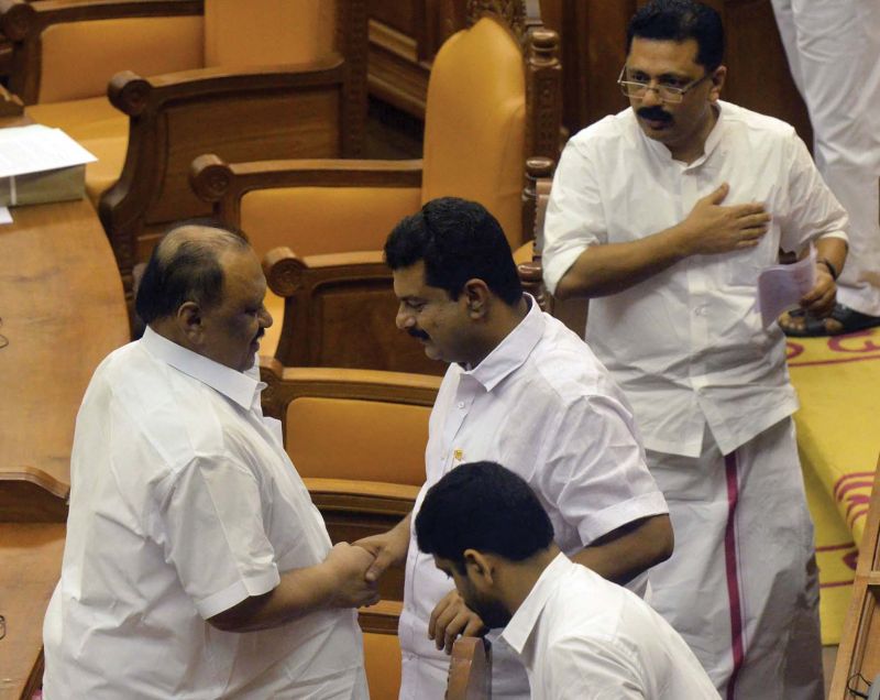 Transport Minister Thomas Chandy greets Nilambur MLA P.V. Anwar after the report was presented. Both members are embroiled in encroachment controversy. Minister for Local Self-Governments K.T. Jaleel looks on. On extreme left, Opposition leader Ramesh Chennithala is seen making a point before the report presentation. 