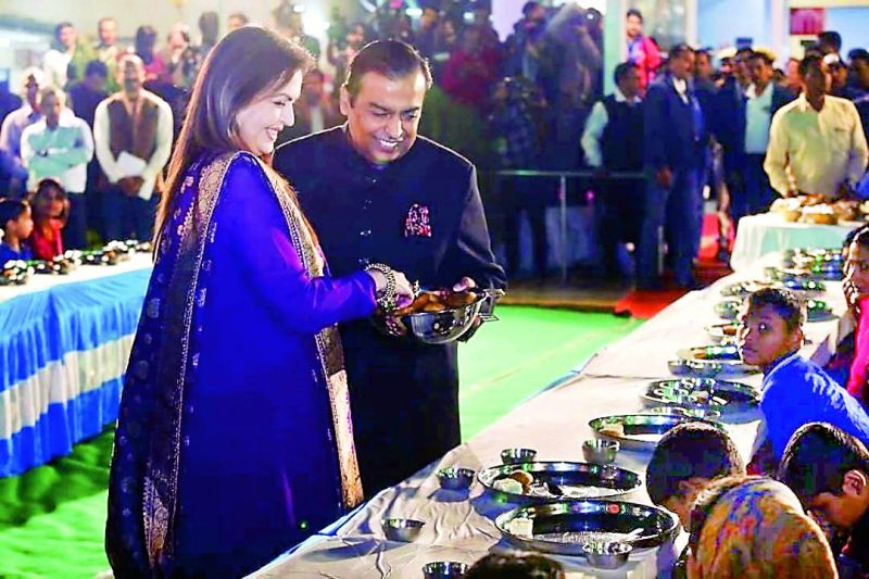 The Ambanis fed 5,100 orphans, homeless and differently-abled thrice a day in a ceremony called Anna Seva'. (Above) Nita and Mukesh Ambani serving the food