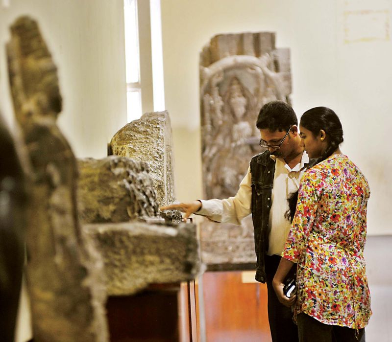 Visitors take a look at the old weapons and sculptures at the Government Museum 