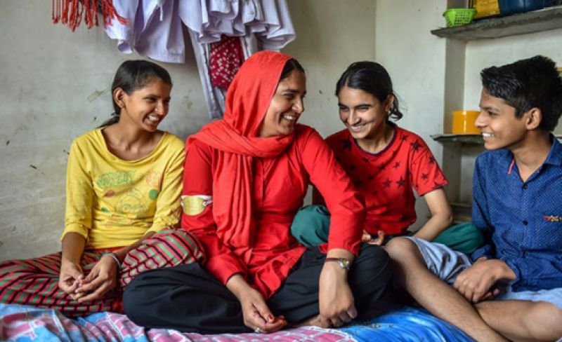 Railway porter Manju Devi shares a light moment with her children, at their home in Jaipur, on Sunday, May 20, 2018. She is the sole breadwinner for her family of three teenagers (Photo: PTI)