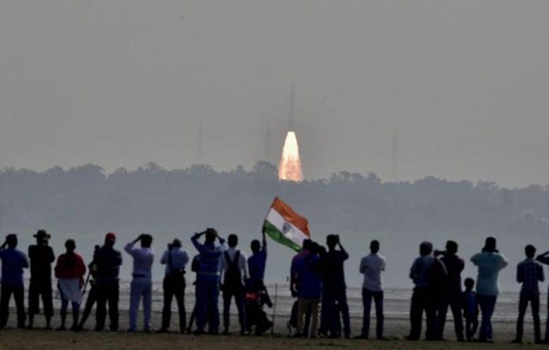 People watch as a rocket from ISRO takes off successfully to launch a record 104 satellites. (Photo: PTI)