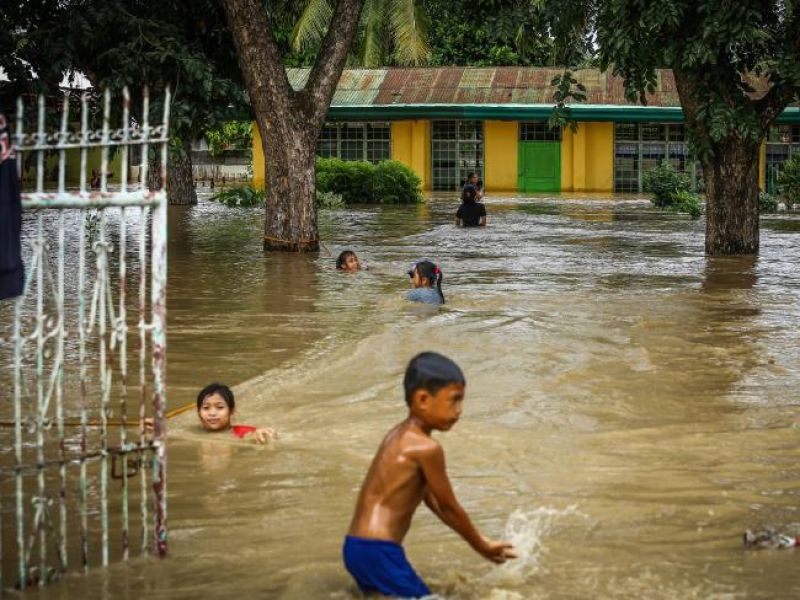 Residents wade through a flooded area in Kabacan, North Cotabato, on the southern island of Mindanao. (Photo: AFP)