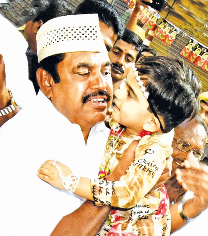 CM dons a Muslim cap and and pets a kid. (Photo: K. Senthil Nathan)