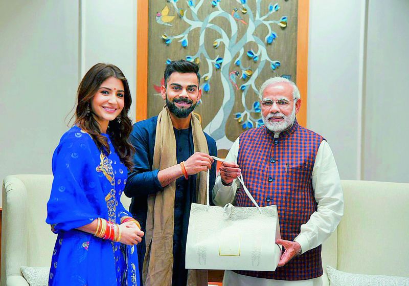 Anushka Sharma and Virat Kohli inviting Prime Minister Narendra Modi to their wedding reception.