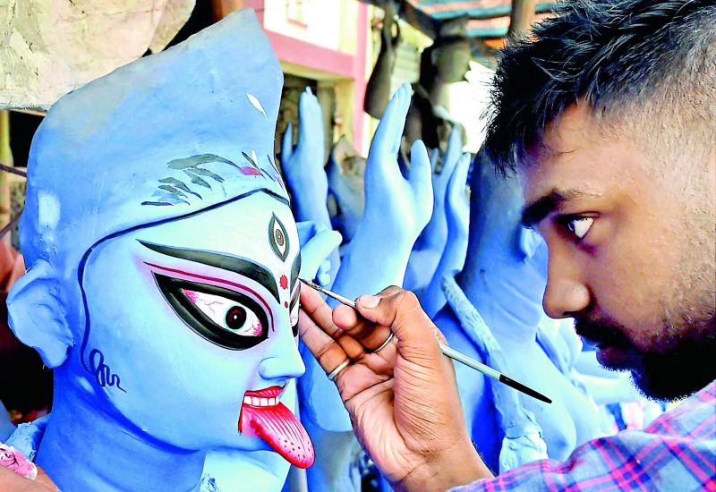 An artist working on the idol of Goddess Kali days before Kali Puja is celebrated in West Bengal.
