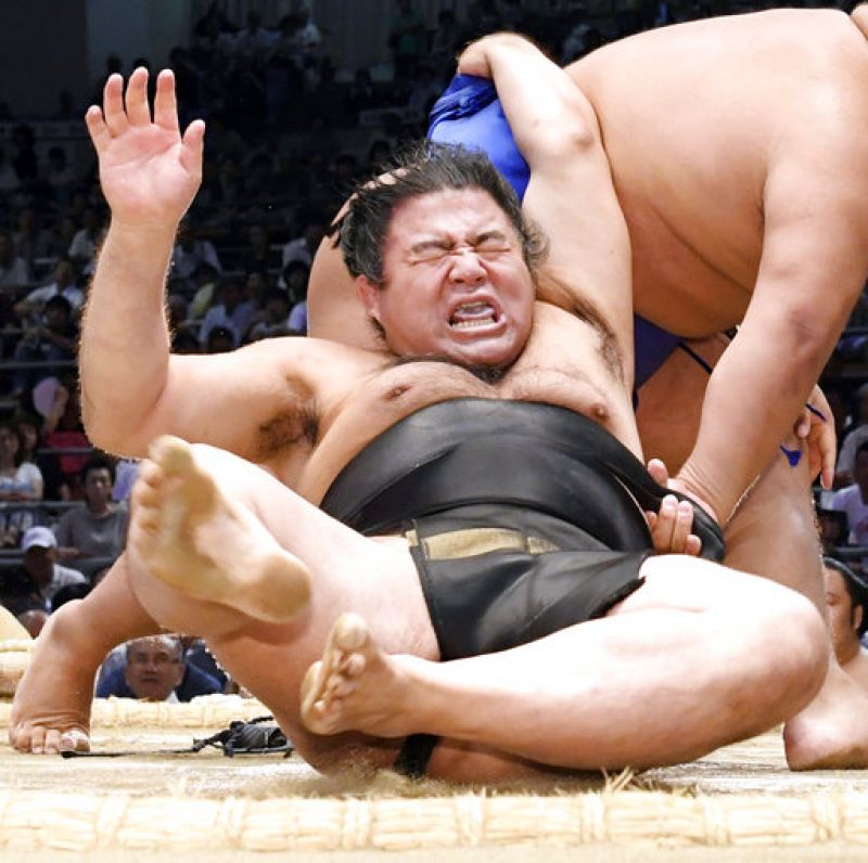 In this Saturday, July 15, 2017 photo, sumo wrester Satoyama is thrown by Yamaguchi during their bout at the Nagoya Summer Grand Sumo tournament in Nagoya, central Japan. (Photo: AP)
