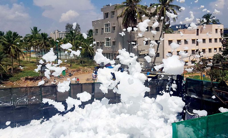 Toxic froth blown by the wind enters nearby houses at Bellandur in Bengaluru on Thursday. (Photo: R. Samuel)