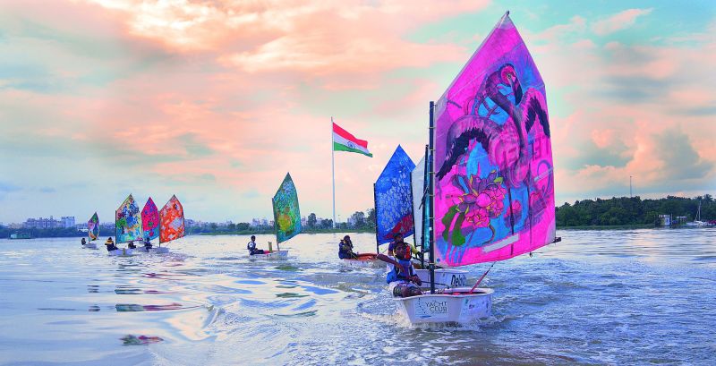 Young sailors practicing at Hussain Sagar with sails rendered in art